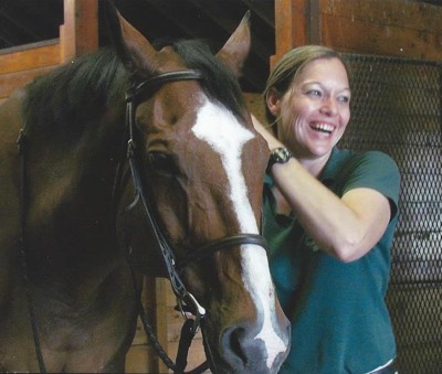 Densie Bean doing an equine massage on a horse